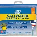 front view of api saltwater test kit in original packaging. it's a semi-clear plastic box with a blue plastic lid. A label sticker covers the front, it's blue and yellow, and says API Saltwater Master Test Kit on it